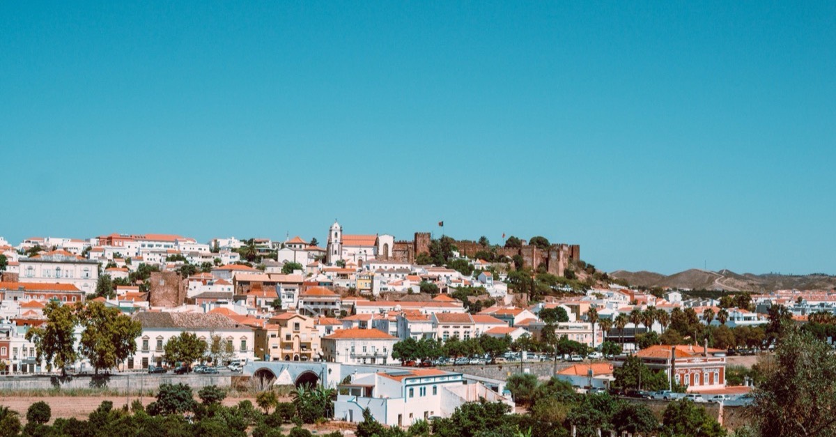 View over the historic town of Silves in the Algarve hinterland with its red sandstone castle and tiled roofs