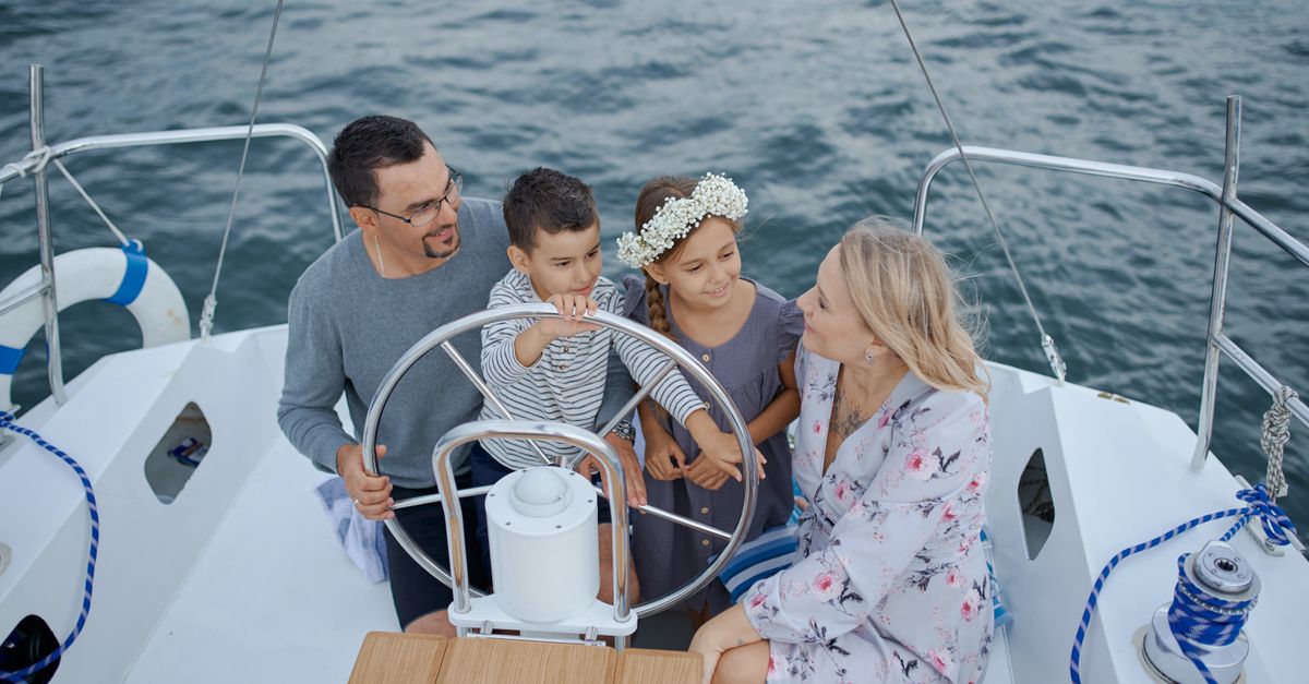 Parents with two small children on board a boat on a calm sea