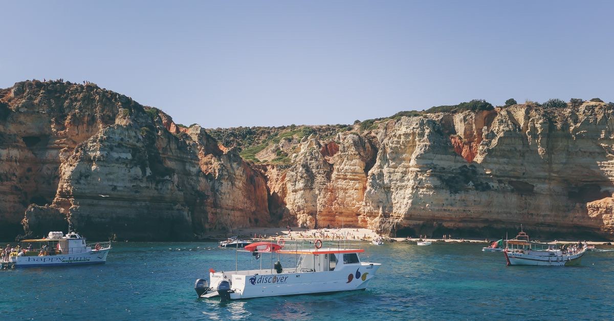A boat tour along the Algarve cliffs in clear blue water