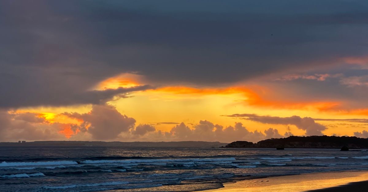 Evening sky over Praia da Rocha with warm light on the rocks